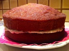 a cake sitting on top of a white plate next to a pink and white napkin