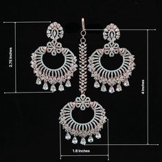 Luxury look American Diamond Chandbali Earrings tikka set from the house of IndianDesigns(Z). Rose Gold plated Earrings and maang tikka set studded with studding high quality American diamond and CZ color stones. Luxury American Diamond Danglers For Festive Occasions, Luxury Traditional Chandbalis With Tilla, Luxury Cutdana Chandbalis For Celebration, Luxury Women's Danglers For Diwali, Luxury Chandbali Danglers For Party, Luxury Chandbali Tikka With Intricate Design, Luxury Silver Tikka In Temple Jewelry Style, Diamond Chandbali Earrings, Diamond Chandbali