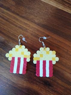 the earrings are made out of legos and have popcorn on them, as if they were