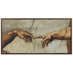 two hands touching each other in front of a painting