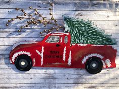 a red truck with a christmas tree on it's bed is painted to look like a car