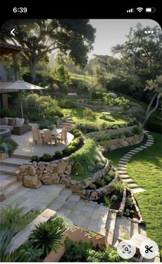 an image of a garden with steps leading up to the lawn and seating area in the background