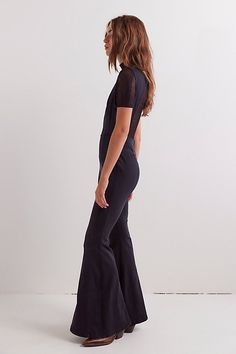 Forever flattering with a retro-inspired touch, this bold jumpsuit from our We The Free collection is perfect for layering and effortless on its own. **Fit:** Slim through the bodice and thigh with flared leg design **Features:** High neckline, keyhole cutout detail at back, button and zip closures, stretch denim fabrication **Why We ❤ It:** Toughened up with moto boots or off-duty with sneakers, this style has endless ways to wear. | We The Free Cayenne Jumpsuit at Free People in Black, Size: 2 Chic Fitted Flare Jumpsuits And Rompers, Spring Flare Fitted Jumpsuits And Rompers, Chic Flare Jumpsuits And Rompers For Spring, Chic Spring Flare Jumpsuits And Rompers, Chic Fitted Wide-leg Jumpsuit, Bold Jumpsuit, Black Leather Jumpsuit, Free People Jumpsuit, Leather Jumpsuit