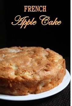 a cake on a white plate with the words french apple cake in front of it