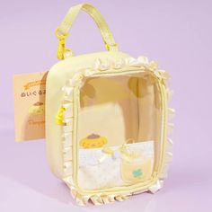 Bring your Pompompurin plushie when you go out using this kawaii ruffled handbag! It features a pacifier-shaped zipper, a mini baby bottle plush charm, and a mini pocket. The bag's handle comes with a hook so you can attach it to your backpack! This bag is made especially for the Pompompurin Enjoy Idol Baby plushie, bu Plushie Bag, Brown Beret, Doll Bag, Kawaii Bags, Cute Squishies, Things I Need To Buy, Inside My Bag, Luxury Lifestyle Dreams, Hello Kitty Items