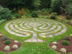 a circular stone maze in the middle of a garden