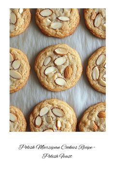 several cookies with almonds are arranged on a baking sheet