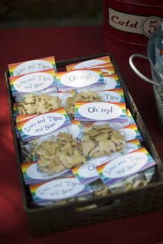 there are many cookies in the box on the table next to the canisters