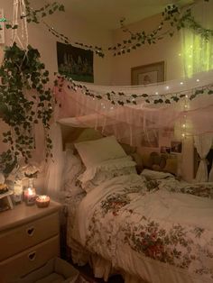 a bedroom with an unmade bed and lots of greenery hanging from the ceiling