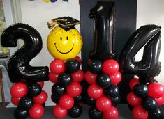 balloons are arranged in the shape of numbers with a smiley face on top and an air filled balloon