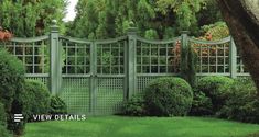 an image of a garden gate in the middle of some trees and grass with bushes around it