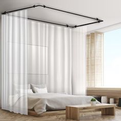 a bedroom with white curtains and wooden floors