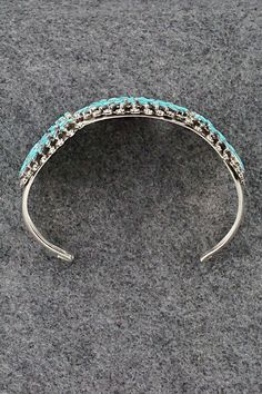 This stunning turquoise and sterling silver bracelet was made by Zuni silversmith Merlinda Chavez. The inside is signed D & M Chavez and Zuni.Size: 5 1/2" (will fit up to a 7" wrist)Gap: 1 1/2"Length: 1 3/4"Free shipping on all orders! We ship with USPS and always include tracking. All orders ship within a day of payment.Returns are accepted up to 30 days after you receive your order. Just send us a message. Our shop offers cash back or store credit. The item must be returned in new condition. Luxury Southwestern Sterling Silver Bracelet, Sterling Silver Bracelet, Native American Jewelry, Turquoise Sterling Silver, Free Jewelry, Sterling Silver Bracelets, Silver Bracelet, Gap, Turquoise