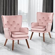 two pink chairs sitting next to each other