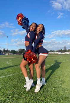 two cheerleaders are posing for the camera