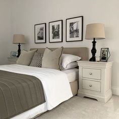 a bedroom with three pictures on the wall above the bed and two nightstands next to it