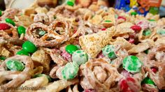 a pile of cereal with candy and pretzels