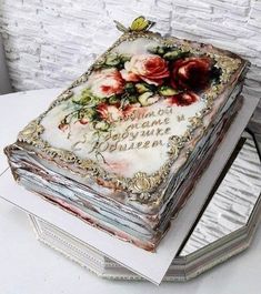 there is a cake that has been decorated with flowers and words on the top layer