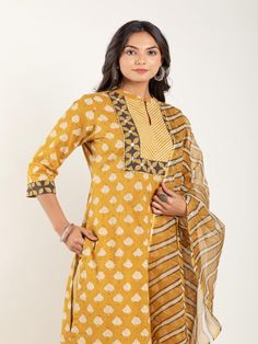 Mustard Yellow dabu flower printed straight kurta, has a mandarin collar, mirror and katha embroidered yoke, three-quarter sleeves and stripes Print afgani Pants has Elasticated Waistband Fabric: 100% Cotton Color: Mustard Yellow Note: Available in other colors Wash Care Instruction - Dry Clean Only The product will be shipped within 15-20 days of order placed Size Chart: Kurta Size XS S M L XL XXL XXXL Bust 36 38 40 42 44 46 Waist 32 34 36 38 40 42 Hip 38 40 42 44 46 48 Shoulder 14 14.5 15 15.5 Straight Kurta, Kurta Set, Mandarin Collar, Three Quarter Sleeves, Yellow Floral, Quarter Sleeve, Floral Printed, Mustard Yellow, Stripe Print