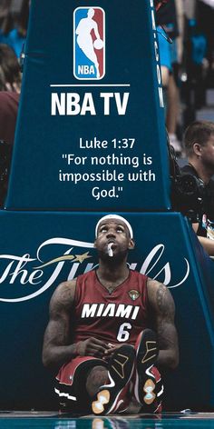 a basketball player sitting on the sidelines with his mouth open in front of him