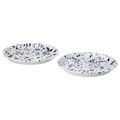 two white and blue plates with splatkles on the rim, one is empty