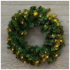 a christmas wreath with lights hanging from it