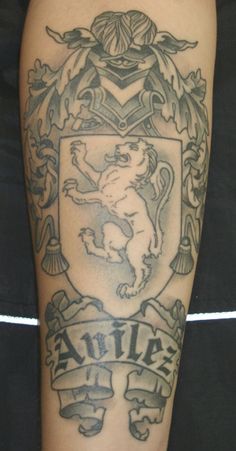 a man with a tattoo on his arm that has a lion and shield in the middle