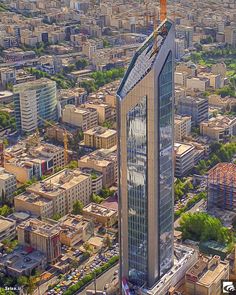 an aerial view of a city with tall buildings and skyscrapers in the foreground