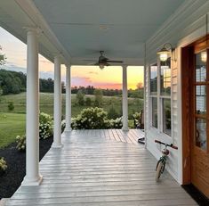 a bicycle parked on the front porch of a house