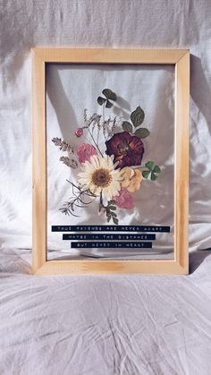 a wooden frame with some flowers in it