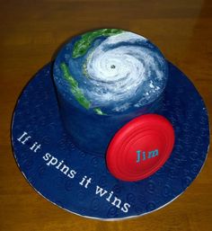 a blue hat with the words if spins it wins on it and a red frisbee