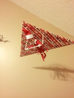 an origami santa clause is hanging from the ceiling