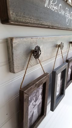 three frames hanging on the wall with twine and rope attached to them, one is holding two pictures