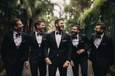 a group of men in tuxedos standing next to each other