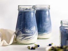 three jars filled with blue and white liquid