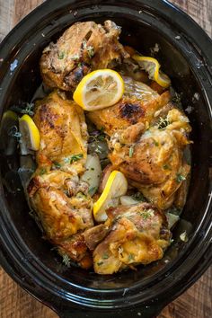 chicken with lemons and herbs in a slow cooker