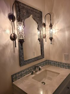 a bathroom with a sink, mirror and lights