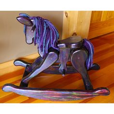 a metal rocking horse sitting on top of a wooden floor