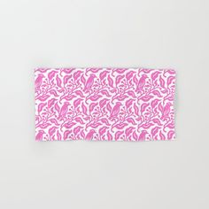 a pink and white towel with an abstract design on the front, folded in half