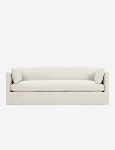 a white couch sitting on top of a wooden floor