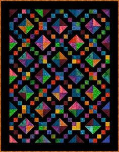 a black quilt with multicolored squares on the front and bottom, along with an orange border