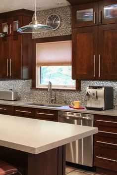 a kitchen with wooden cabinets and stainless steel appliances