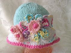 a crocheted hat with flowers on it