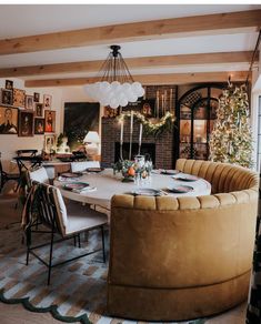 a living room with a couch, table and christmas decorations on the wall behind it