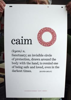 a person holding up a sign with the words calm on it in front of their face