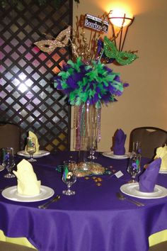 the table is set with purple and green decorations