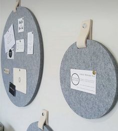 two circular bulletin boards with magnets attached to the back of each board, hanging on a white wall