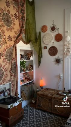 a living room filled with lots of furniture and decor on the wall next to a window