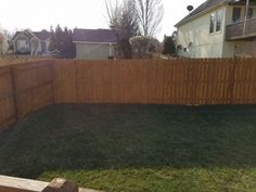 a wooden fence in front of a house