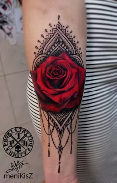 a red rose tattoo on the arm